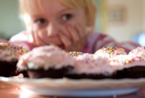 getty_rm_photo_of_child_looking_at_cupcakes