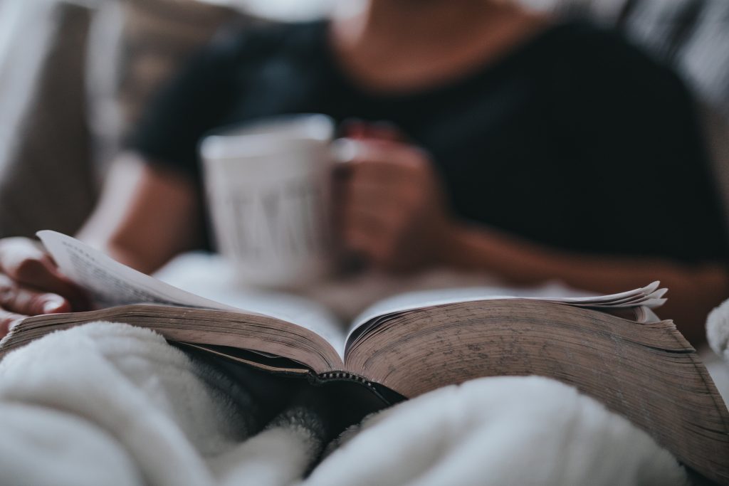 Man reading book in bed